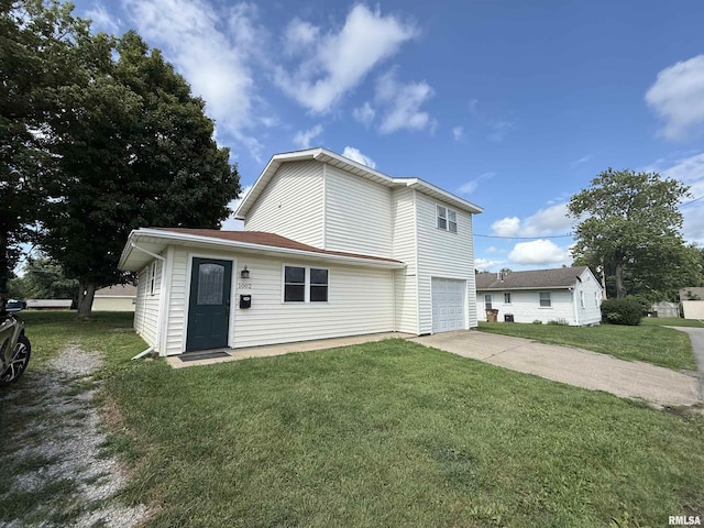 1002 Elm St, Marion, IL 62959 - view of front of home featuring a garage, concrete driveway, and a front yard