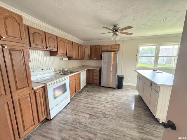 1002 Elm St, Marion, IL 62959 - kitchen with white appliances, ornamental molding, ceiling fan, light countertops, and light wood finished floors