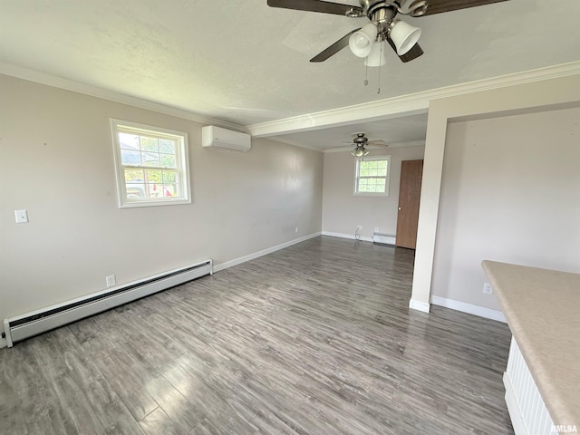 1002 Elm St, Marion, IL 62959 - spare room with baseboard heating, crown molding, a wall mounted AC, wood finished floors, and a ceiling fan