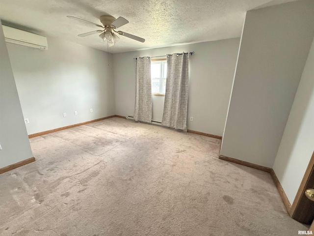 1002 Elm St, Marion, IL 62959 - carpeted spare room with an AC wall unit, a ceiling fan, a baseboard radiator, and a textured ceiling