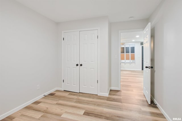 302 S Gray Dr, Carbondale, IL 62901 - unfurnished bedroom with light wood-style flooring, recessed lighting, and a closet