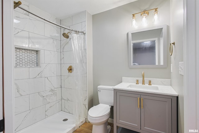 302 S Gray Dr, Carbondale, IL 62901 - bathroom featuring vanity, tiled shower, and wood finished floors