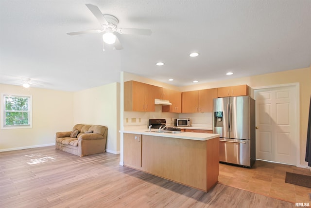 416 W Harrison St, Carrier Mills, IL 62917 - kitchen featuring appliances with stainless steel finishes, light countertops, a ceiling fan, a peninsula, and open floor plan