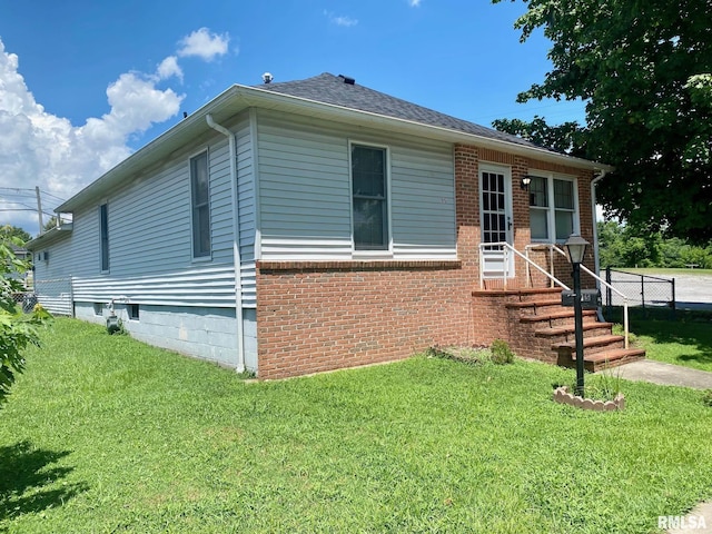 1915 E Oak St, West Frankfort, IL 62896 - view of front of property featuring a front lawn, brick siding, and roof with shingles