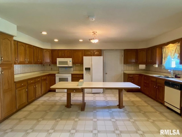 117 N Plains Ave, Marion, IL 62959 - kitchen with white appliances, light flooring, brown cabinets, recessed lighting, and backsplash