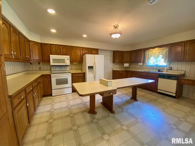 117 N Plains Ave, Marion, IL 62959 - kitchen featuring white appliances, light floors, light countertops, and brown cabinets
