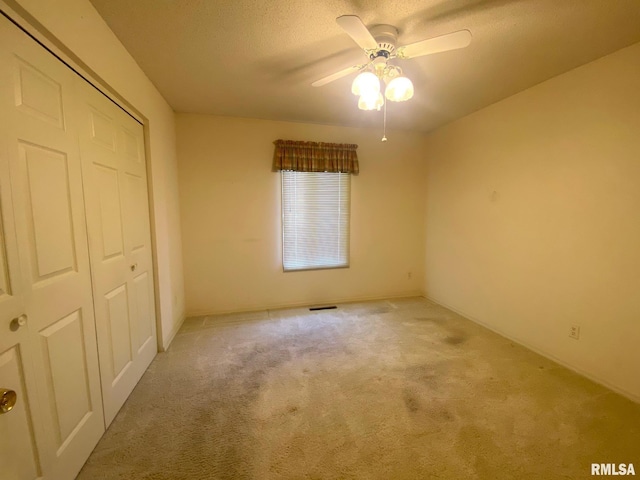 117 N Plains Ave, Marion, IL 62959 - unfurnished bedroom with carpet floors, a closet, a textured ceiling, and ceiling fan