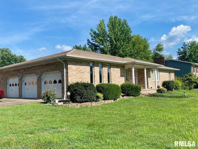 117 N Plains Ave, Marion, IL 62959 - ranch-style house with brick siding, a front yard, an attached garage, and driveway