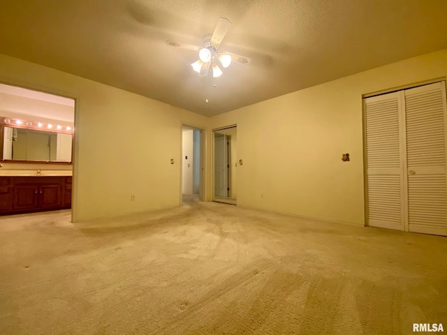 117 N Plains Ave, Marion, IL 62959 - unfurnished bedroom featuring light carpet, connected bathroom, a textured ceiling, and ceiling fan