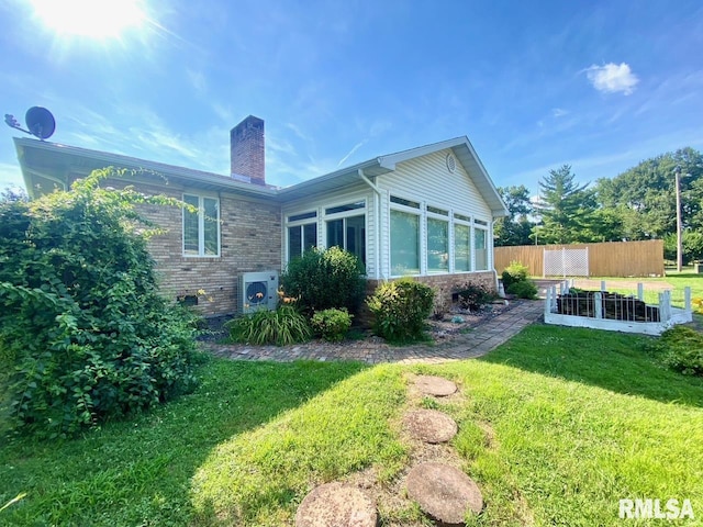 117 N Plains Ave, Marion, IL 62959 - back of house with a chimney, a vegetable garden, a sunroom, and brick siding