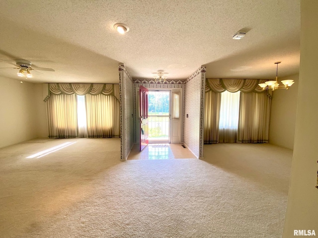117 N Plains Ave, Marion, IL 62959 - spare room featuring a textured ceiling, carpet flooring, a chandelier, a smoke detector, and a ceiling fan