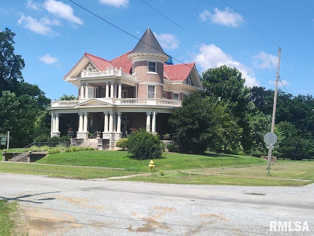 319 High St, Mound City, IL 62963 - victorian house featuring a balcony, a porch, and a front yard