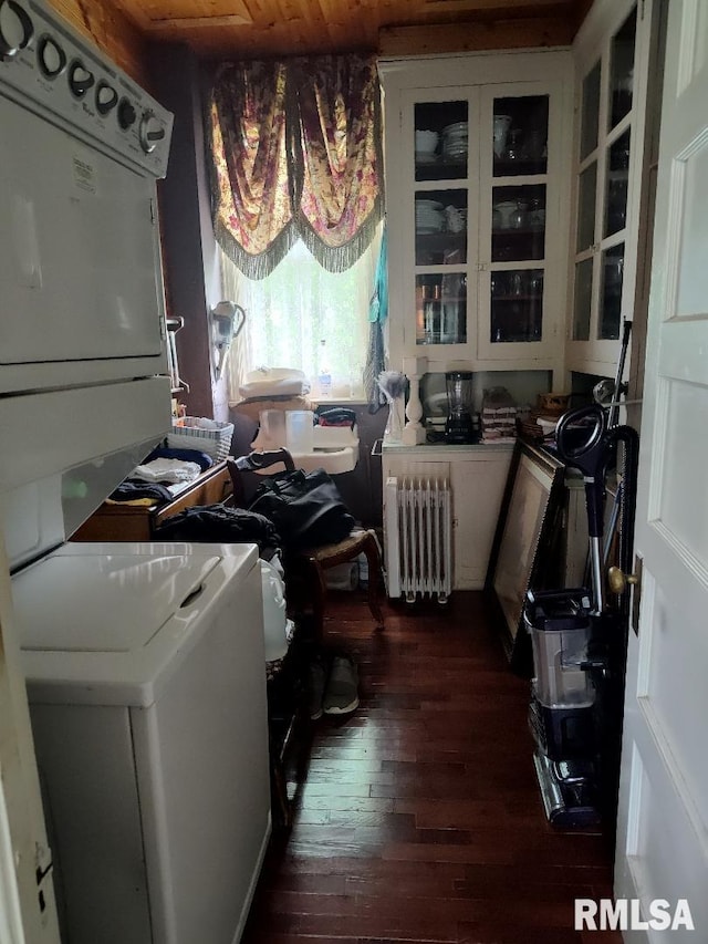 319 High St, Mound City, IL 62963 - laundry area featuring radiator, stacked washing machine and dryer, and dark wood-style floors