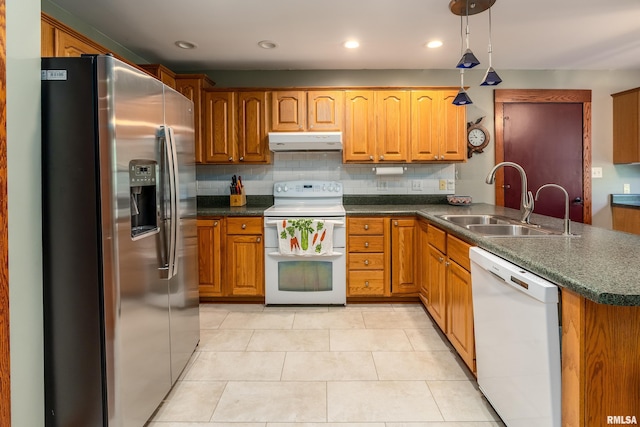 243 Pump Station Rd, Makanda, IL 62958 - kitchen with white appliances, under cabinet range hood, dark countertops, brown cabinets, and recessed lighting