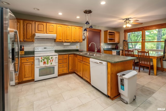 243 Pump Station Rd, Makanda, IL 62958 - kitchen featuring white appliances, under cabinet range hood, ceiling fan, dark countertops, and a peninsula