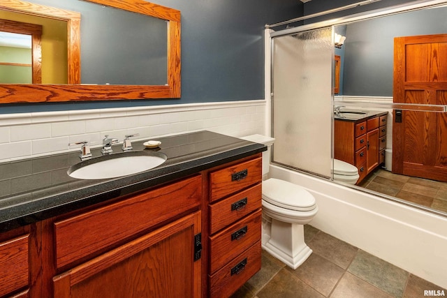 243 Pump Station Rd, Makanda, IL 62958 - bathroom with vanity, a wainscoted wall, enclosed tub / shower combo, and tile patterned flooring