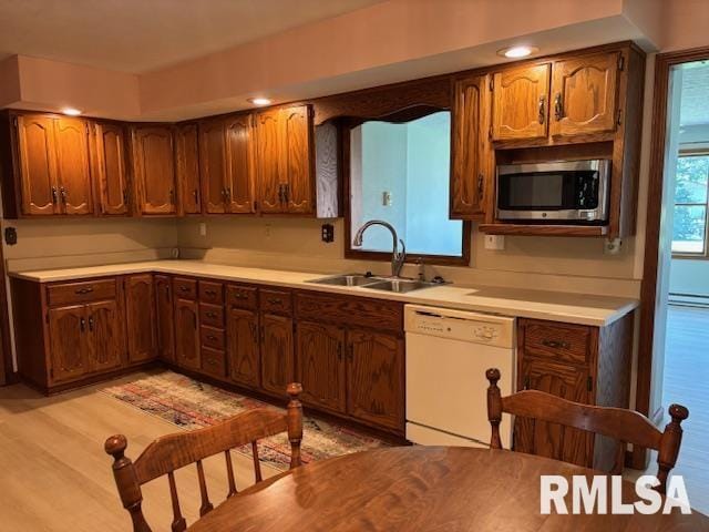 15944 Moellers Rd, Marion, IL 62959 - kitchen featuring white dishwasher, stainless steel microwave, light countertops, a baseboard radiator, and light wood-type flooring