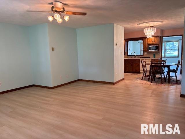 15944 Moellers Rd, Marion, IL 62959 - unfurnished dining area featuring light wood finished floors, a ceiling fan, and a chandelier