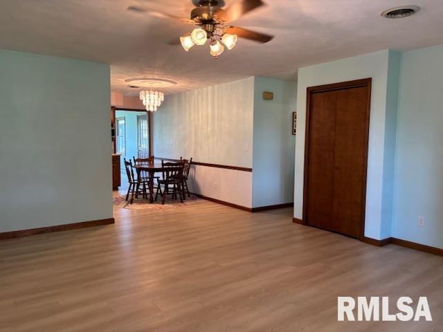 15944 Moellers Rd, Marion, IL 62959 - unfurnished dining area with a ceiling fan, wood finished floors, and a chandelier