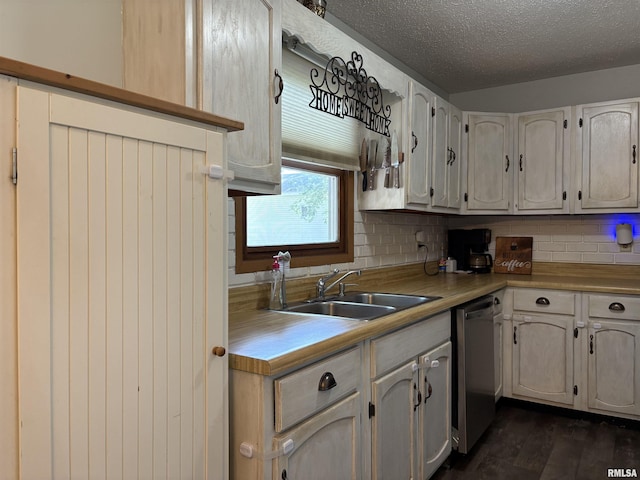 2119 Rains St, Murphysboro, IL 62966 - kitchen featuring stainless steel dishwasher, decorative backsplash, light countertops, dark wood-style floors, and a textured ceiling