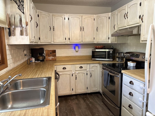 2119 Rains St, Murphysboro, IL 62966 - kitchen featuring stainless steel appliances, extractor fan, light countertops, dark wood-style floors, and decorative backsplash