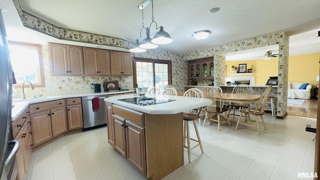 1016 Michael Ln, West Frankfort, IL 62812 - kitchen with dishwasher, black electric cooktop, a breakfast bar area, light countertops, and a kitchen island