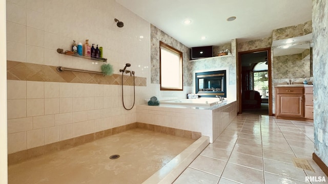 1016 Michael Ln, West Frankfort, IL 62812 - bathroom with tile patterned floors, a bath, vanity, healthy amount of natural light, and tile walls