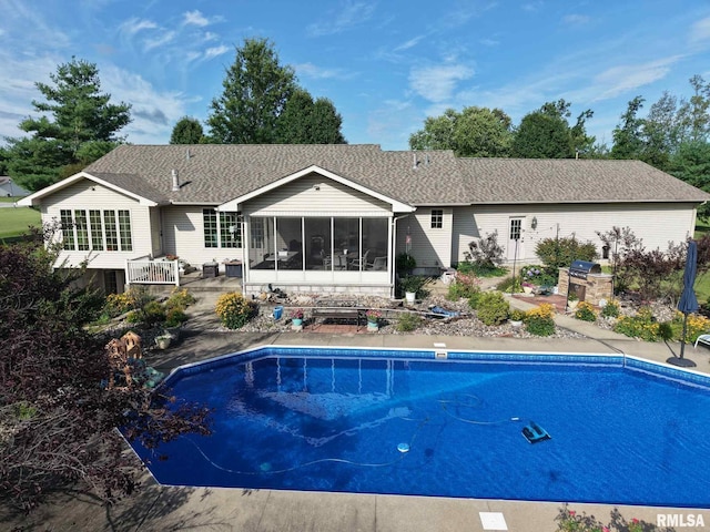 1016 Michael Ln, West Frankfort, IL 62812 - back of property with a sunroom, exterior kitchen, an outdoor pool, and roof with shingles