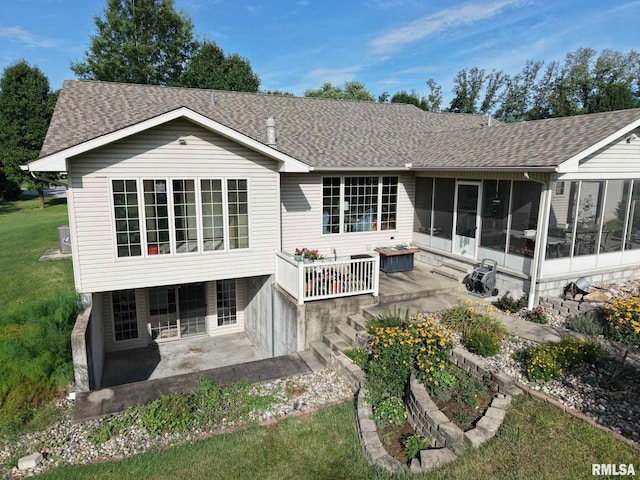 1016 Michael Ln, West Frankfort, IL 62812 - back of property with a sunroom, a patio, a shingled roof, and a yard