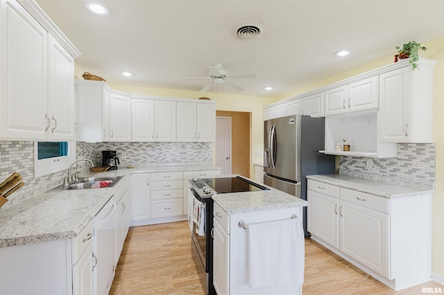 11823 Taylor Dr, Marion, IL 62959 - kitchen with electric range, stainless steel refrigerator with ice dispenser, dishwasher, ceiling fan, and a center island