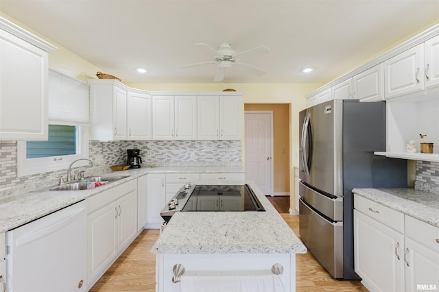 11823 Taylor Dr, Marion, IL 62959 - kitchen featuring white dishwasher, freestanding refrigerator, range, a center island, and backsplash