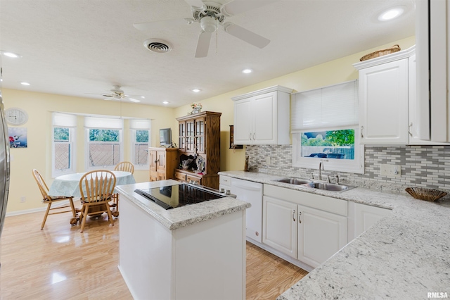 11823 Taylor Dr, Marion, IL 62959 - kitchen with ceiling fan, dishwasher, black electric cooktop, a center island, and tasteful backsplash