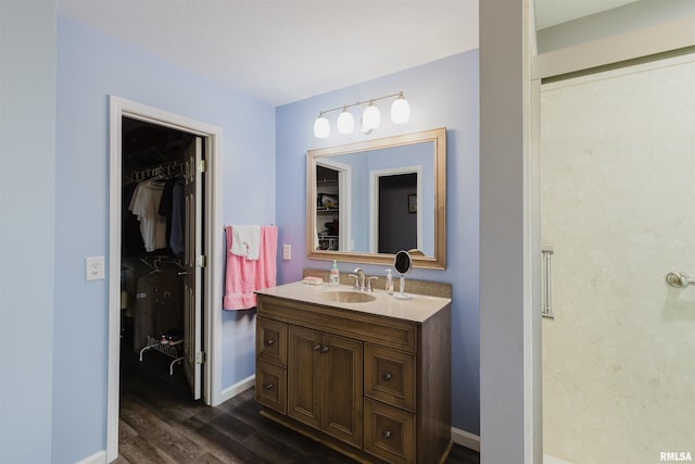11823 Taylor Dr, Marion, IL 62959 - bathroom with vanity, wood finished floors, and a walk in closet