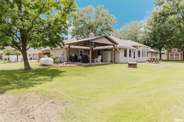 11823 Taylor Dr, Marion, IL 62959 - back of property featuring a storage unit, a patio area, and a yard
