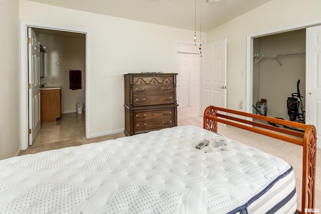 508 Lexington Ct, Carbondale, IL 62901 - bedroom featuring light colored carpet, ensuite bathroom, and two closets
