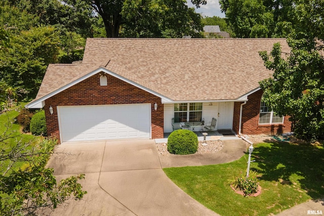 508 Lexington Ct, Carbondale, IL 62901 - view of front of property with concrete driveway, an attached garage, brick siding, a front lawn, and a shingled roof