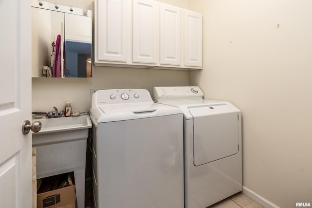 1002 Villa Ct, Carbondale, IL 62901 - laundry room featuring washer and dryer, cabinet space, and light tile patterned flooring