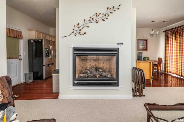 1002 Villa Ct, Carbondale, IL 62901 - living area featuring a fireplace, carpet floors, a chandelier, and wood finished floors