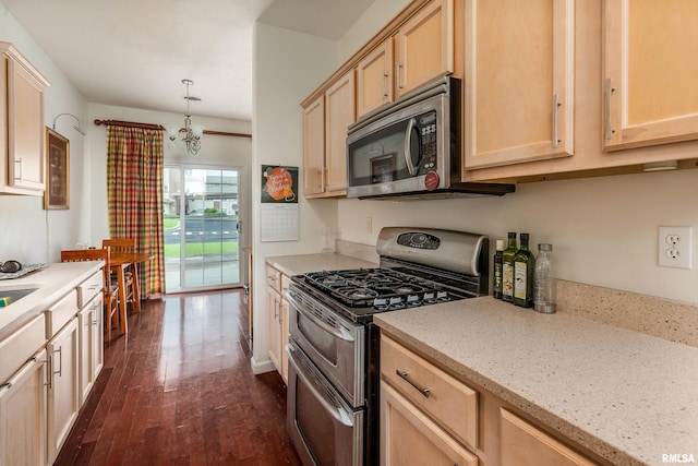 1002 Villa Ct, Carbondale, IL 62901 - kitchen featuring appliances with stainless steel finishes, light brown cabinets, dark wood-style floors, light stone countertops, and a chandelier