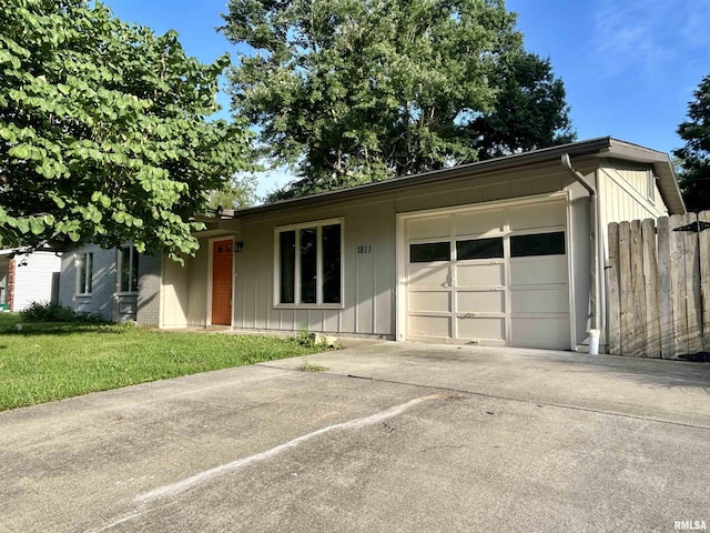 1811 W Freeman St, Carbondale, IL 62901 - single story home with concrete driveway, an attached garage, and board and batten siding