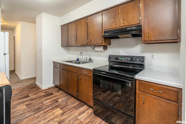 1811 W Freeman St, Carbondale, IL 62901 - kitchen with black electric range, under cabinet range hood, dark wood-style floors, and light countertops