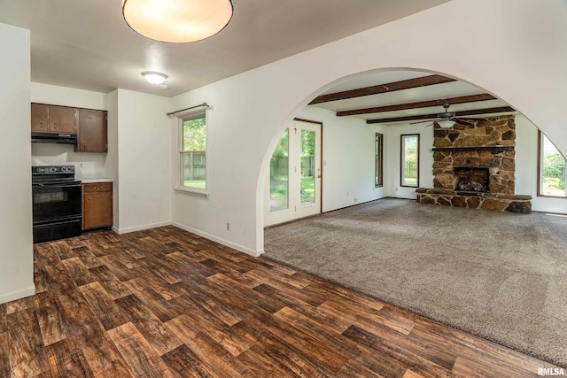 1811 W Freeman St, Carbondale, IL 62901 - unfurnished living room featuring dark wood-style floors, ceiling fan, arched walkways, plenty of natural light, and beam ceiling