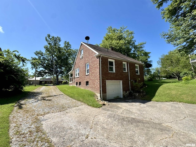 403 Freeman St, Anna, IL 62906 - view of side of property with concrete driveway, brick siding, an attached garage, and a yard