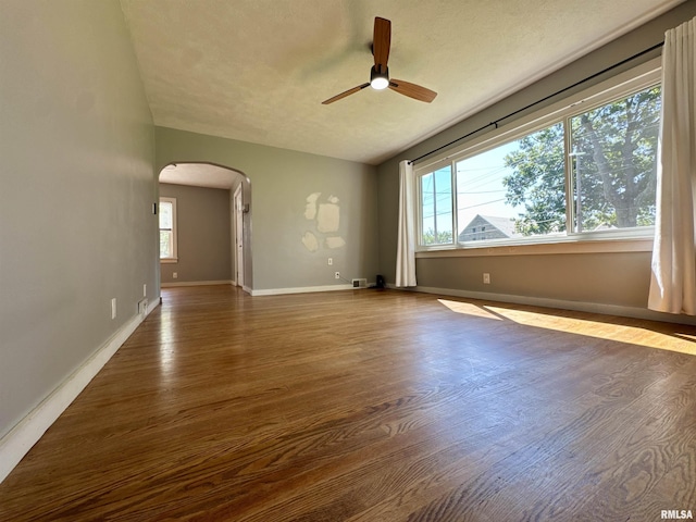 403 Freeman St, Anna, IL 62906 - spare room featuring arched walkways, a ceiling fan, plenty of natural light, and wood finished floors
