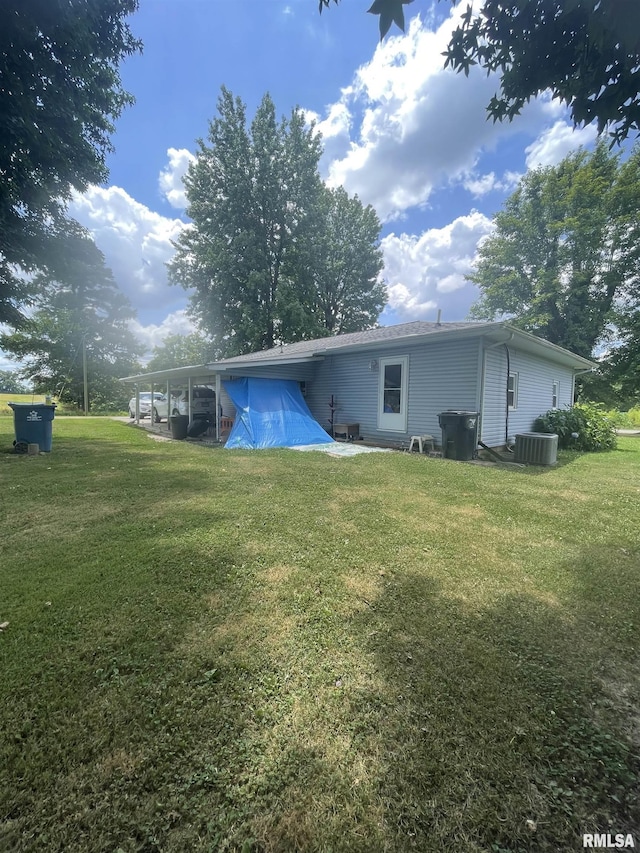 17726 Quiet Acres Rd, Scheller, IL 62883 - back of property featuring an attached carport and a yard