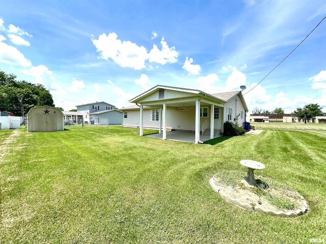 1915 W 4th St, Centralia, IL 62801 - rear view of property with a patio, a storage unit, a lawn, and ceiling fan