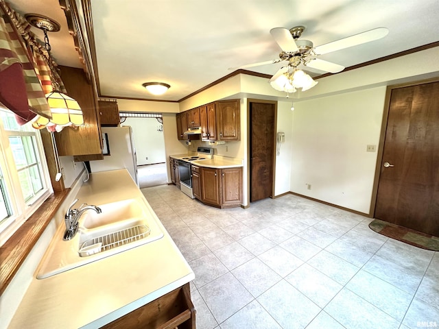 1915 W 4th St, Centralia, IL 62801 - kitchen featuring white appliances, light countertops, a ceiling fan, light tile patterned floors, and crown molding