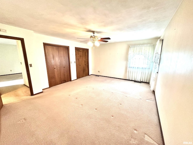 1915 W 4th St, Centralia, IL 62801 - unfurnished bedroom featuring two closets, carpet, and ceiling fan