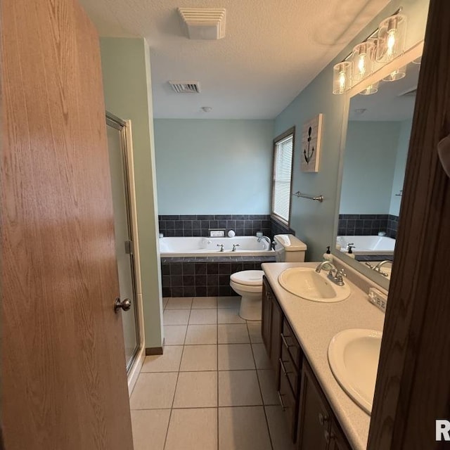 418 Michelle Ln, Walcott, IA 52773 - full bathroom with a garden tub, a stall shower, tile patterned floors, double vanity, and a textured ceiling