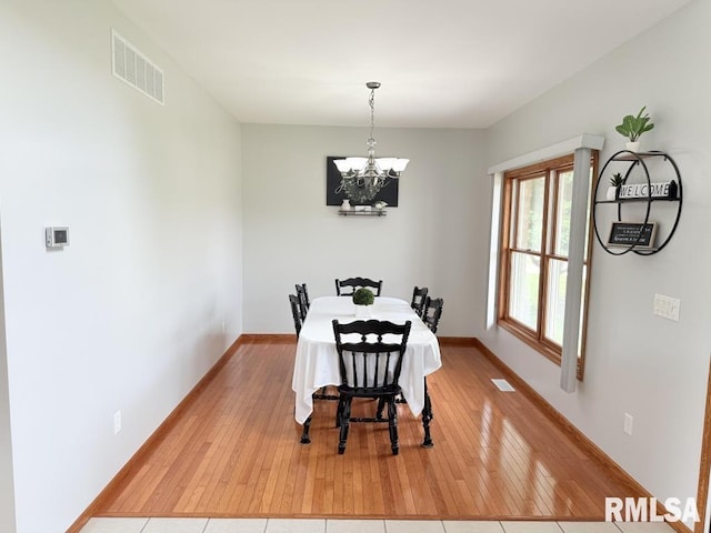 418 Michelle Ln, Walcott, IA 52773 - dining room featuring light wood-style floors and a chandelier